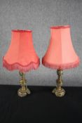 A pair of brass lamps with matching pink shades. H.38cm. Circa 1940. In need of restoration. (each)