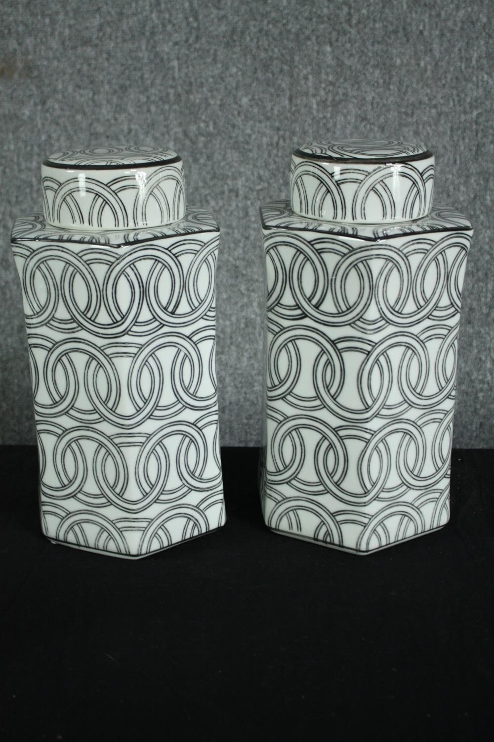 A pair of black and white lidded ginger jars decorated with chainlink pattern. H.31cm. (each)