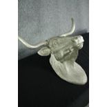 A fibreglass horned bulls head finished in silver. H.54 W.73cm.