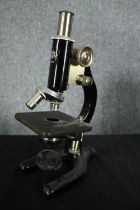 A WR Prior Microscope in a wooden travel case. Brass and black lacquered metal on a Y-shaped foot.