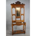 A Victorian period oak hall hat /coat and cane stand, dating from around 1890. With a shaped cornice