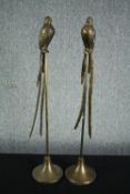 A pair of metal birds in a painted brass finish on their perches. H.84cm. (each)