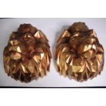 A pair of lion heads. Resin and finished in gold. H.35 W.30 cm.(each)