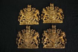Four coats of arms. Wall plaques. Moulded and finished in gold. H.17 W.17cm. (each)