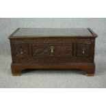 An 18th century oak cupboard base profusely carved allover with scrolling foliate motifs. H.41 W.