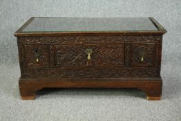 An 18th century oak cupboard base profusely carved allover with scrolling foliate motifs. H.41 W.