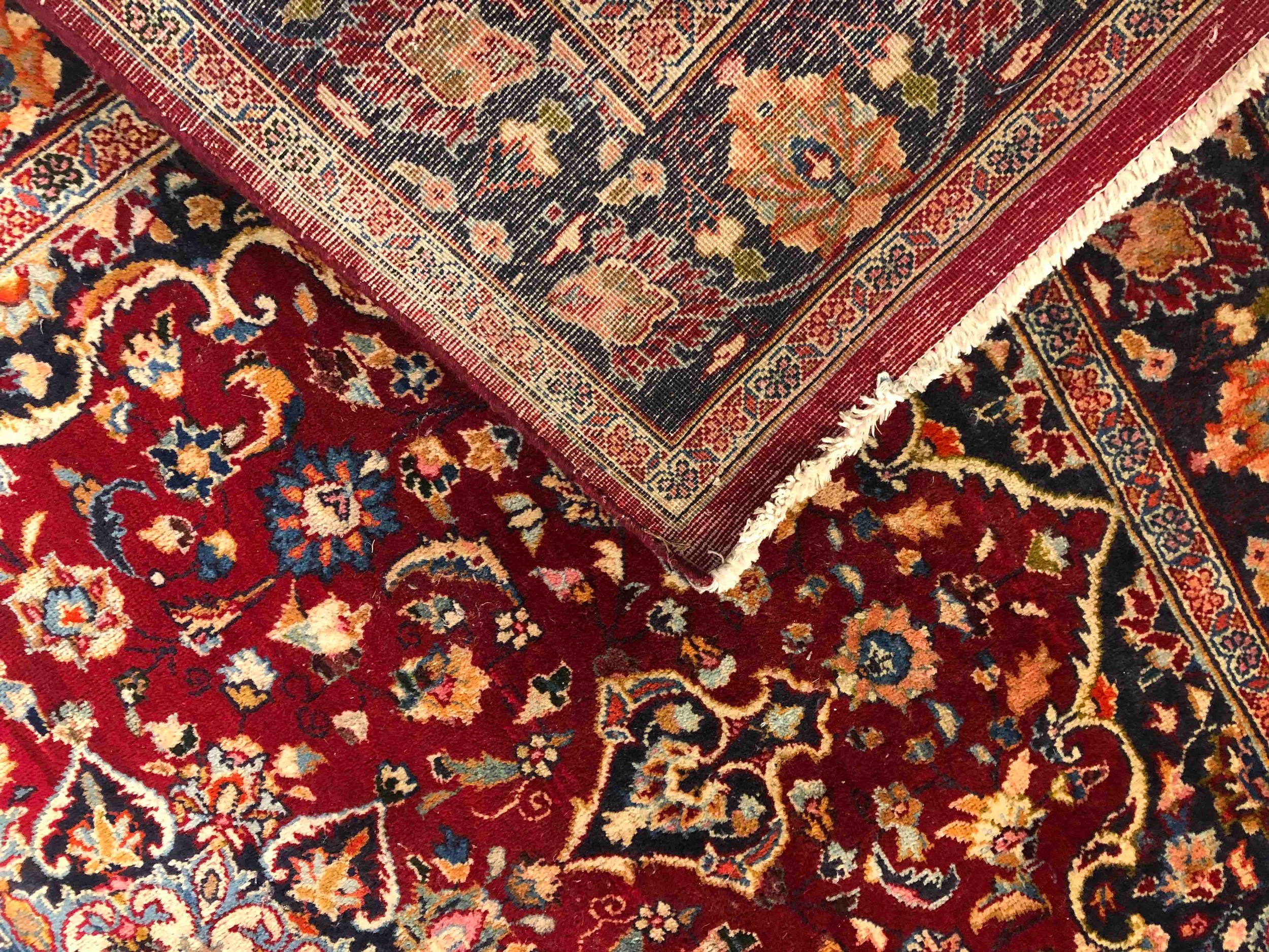 A Persian carpet with flowerhead motifs across the field within naturalistic foliate borders. L. - Image 3 of 3