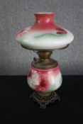An early twentieth century hurricane lamp with hand painted floral decoration. Brass. H.53cm.
