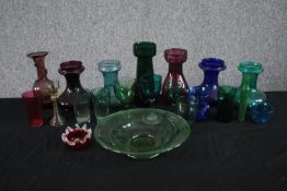 An assortment of 19th and early 20th century coloured blown glass, including Bristol green wine