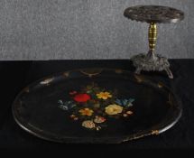 A twentieth century lacquered paper mache tray with floral decoration supported by an iron stand.