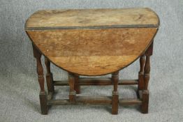 Dining table, mid century oak drop flap. H.74 W.107 D.90cm.