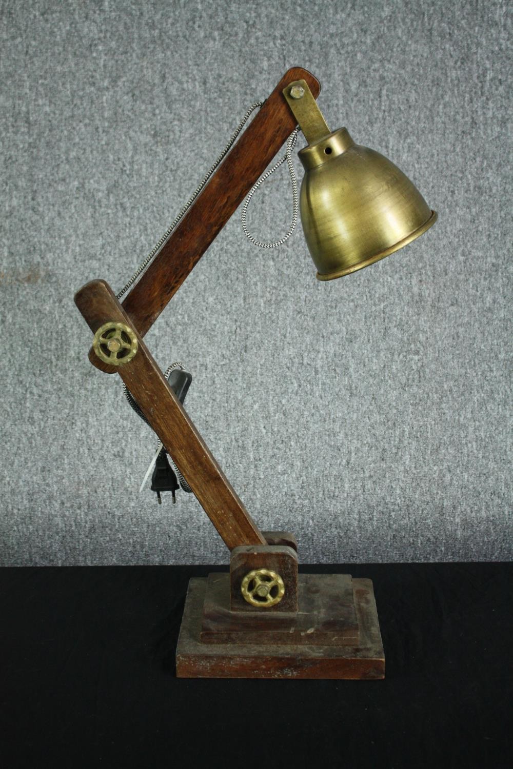 A wooden anglepoise type lamp with a metal shade and fixings. H.77cm.