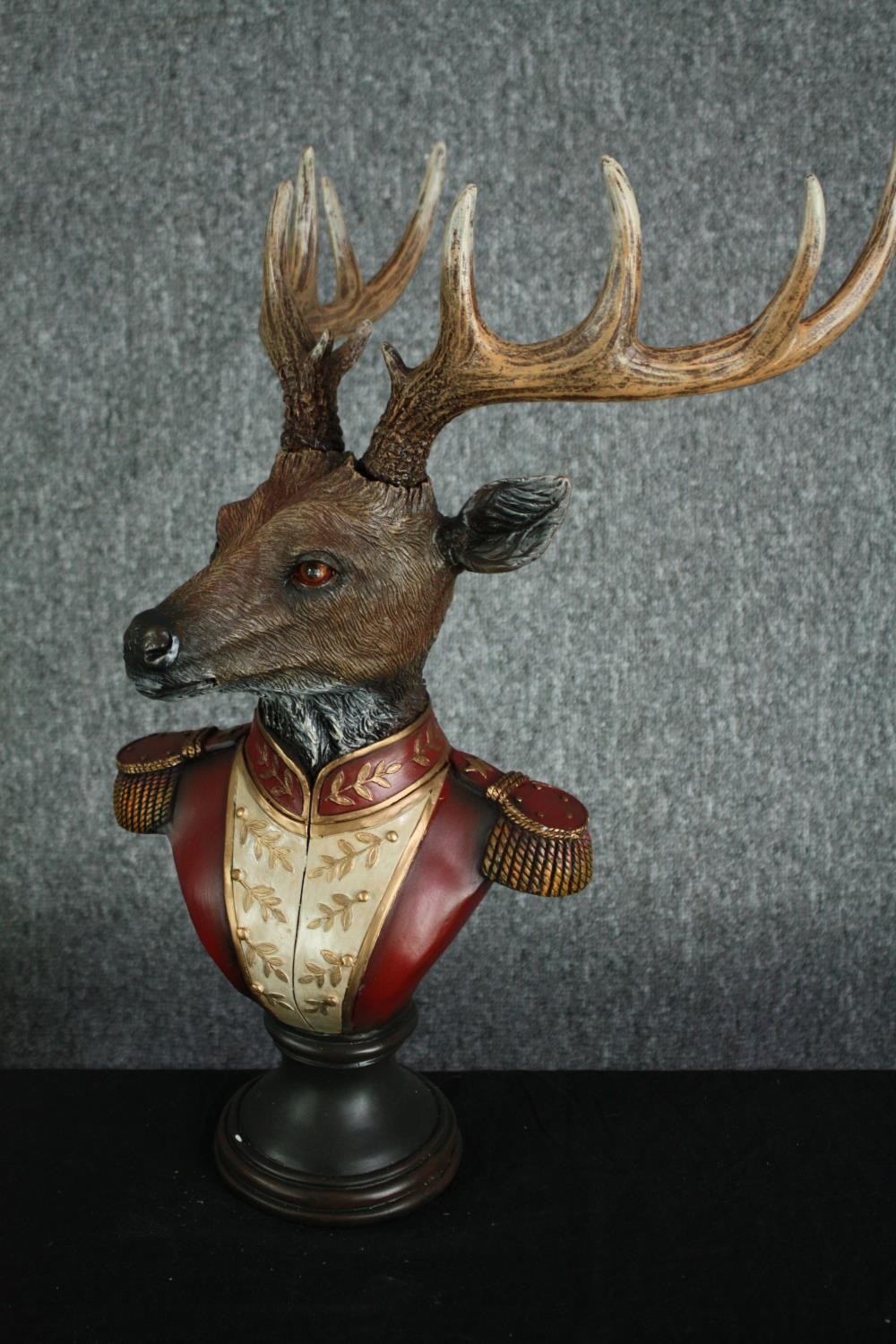 A horned stag bust in Napoleonic uniform. Poly-resin and hand painted. H.42cm.H.48cm. - Image 2 of 3