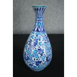 An early 20th century Multani blue and white floral hand painted vase. A little chipped with signs