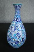 An early 20th century Multani blue and white floral hand painted vase. A little chipped with signs