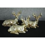 Three gold painted poly-resin reindeer figures. H.20 W.27cm. (each)