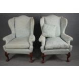 Armchairs, early Georgian wingback style on carved walnut cabriole supports.