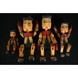 Four carved and hand painted Pinocchio puppets. H.30cm. (largest)