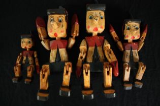 Four carved and hand painted Pinocchio puppets. H.30cm. (largest)