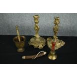 A collection of brassware and a horn. Including a pair of Rococo style candle holders, a bell, and a