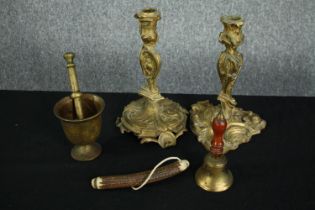A collection of brassware and a horn. Including a pair of Rococo style candle holders, a bell, and a