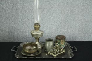A mixed collection of pewterware and a vintage tin box. Includes a tray, toast rack, lantern etc.