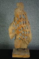 A driftwood abstract sculpture. Honeycombed on a hardwood stand. H.80cm.