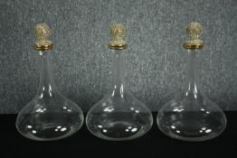 Three modern glass decanters with decorative diamante stoppers. H.33cm.