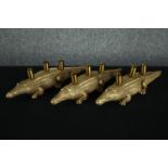 Three modern crocodiles candle holders. Moulded finished in gold. H.12 L.45cm. (each)