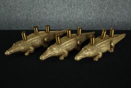 Three modern crocodiles candle holders. Moulded finished in gold. H.12 L.45cm. (each)