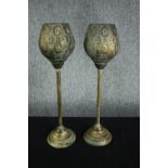 A pair of modern candle holders. Light metal in a painted distressed finish with two glass candle