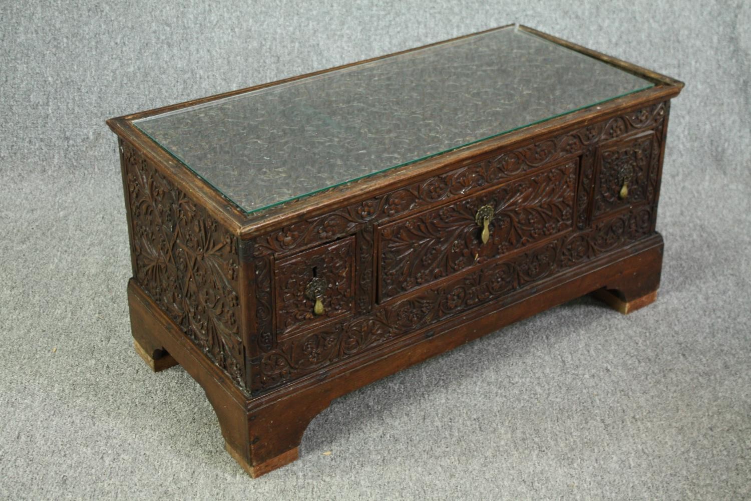 An 18th century oak cupboard base profusely carved allover with scrolling foliate motifs. H.41 W. - Image 3 of 11