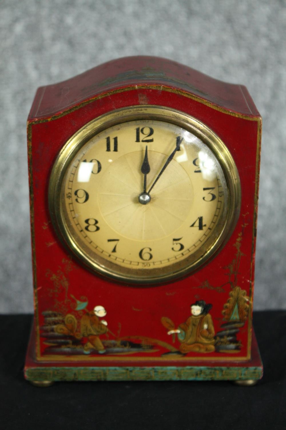 An early twentieth century Chinoiserie mantle clock. In a hand painted and lacquered wooden case.