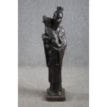 A large figurine. A Chinese man holding a Foo dog. Concrete painted in a bronze like patina. Very