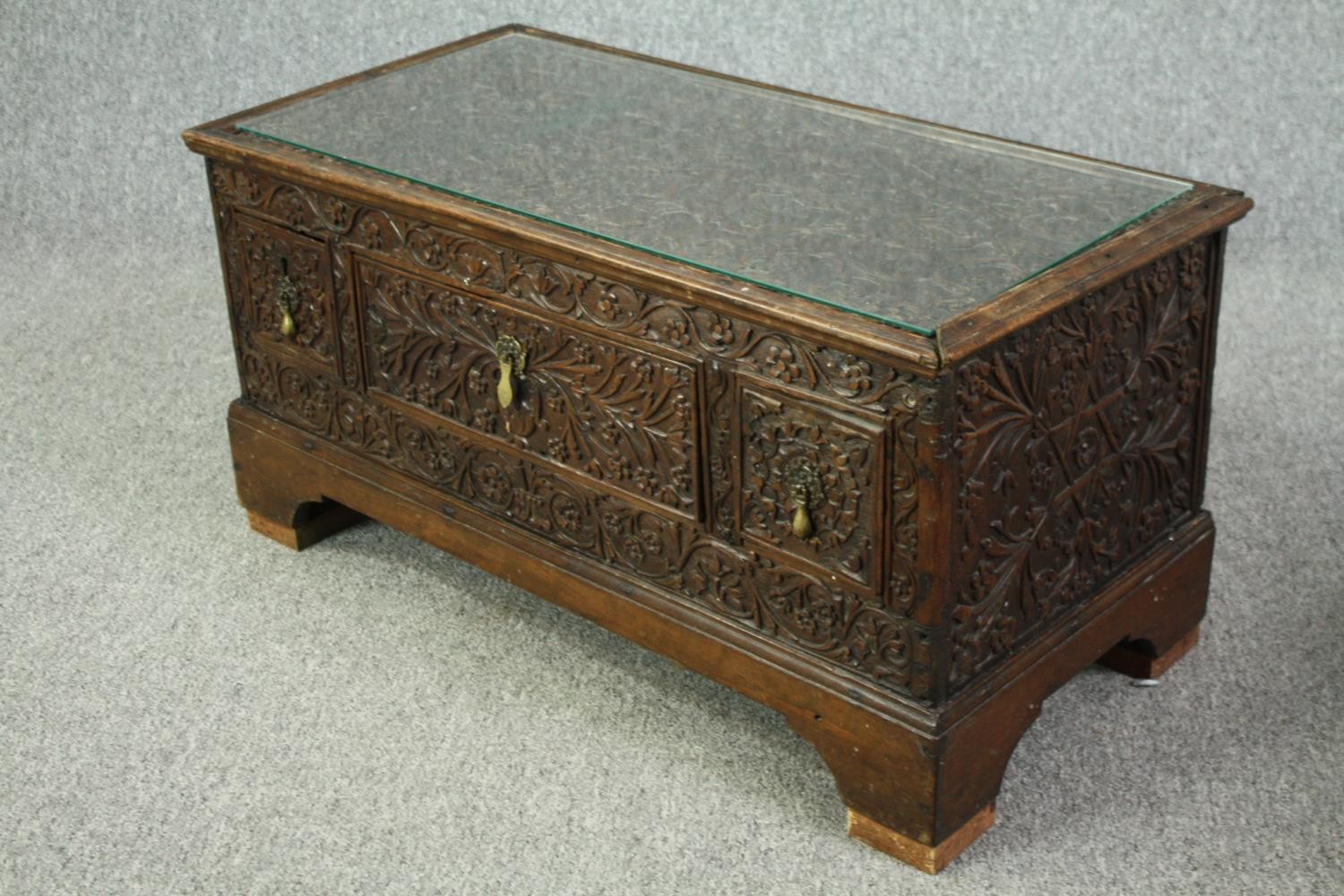 An 18th century oak cupboard base profusely carved allover with scrolling foliate motifs. H.41 W. - Image 4 of 11