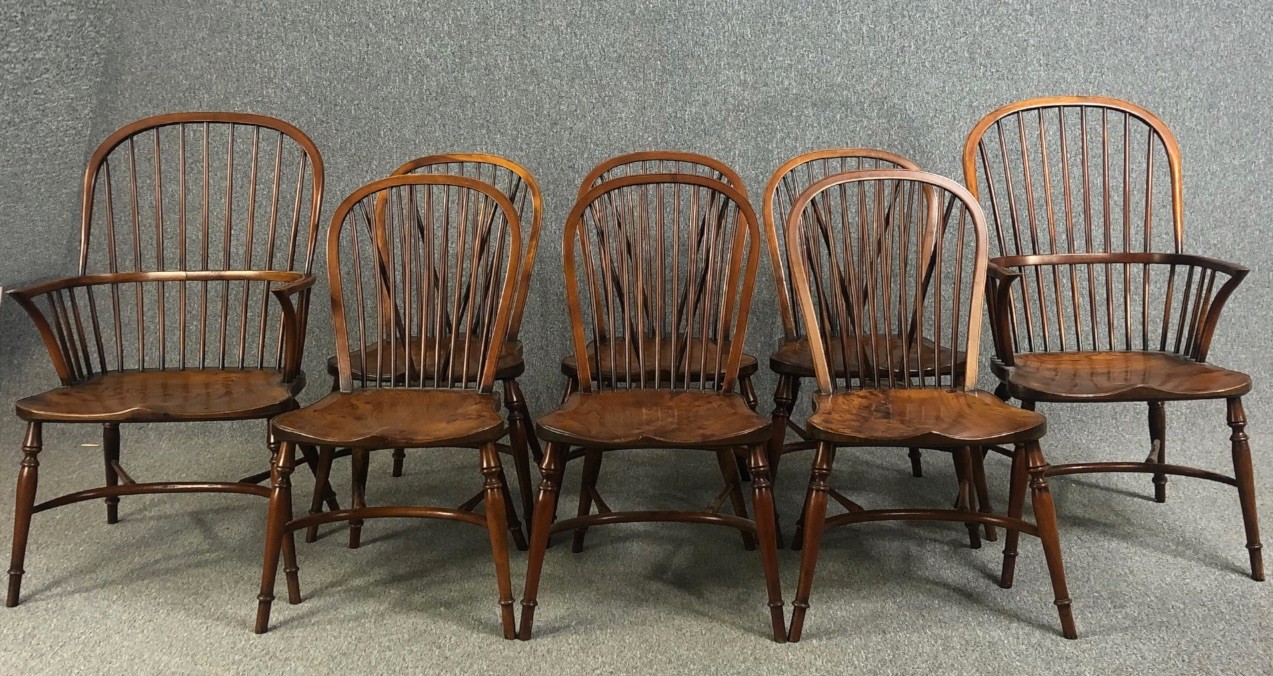 Dining chairs, a set of eight Windsor stick back style in yew with elm saddle seats on crinoline