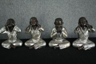 Four modern seated Shaolin monk figurines. See, hear, speak no evil. H.26cm. (each)
