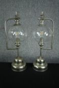 Two battery powered garden lanterns. Metal stand with glass bulb shades. H.56cm. (each)