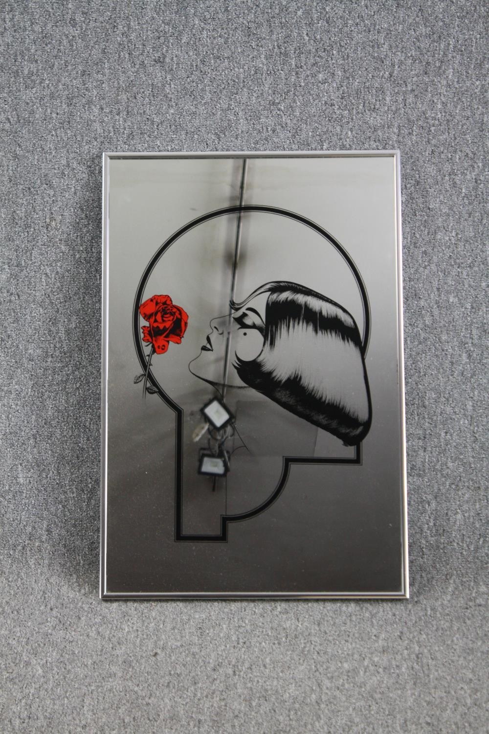 Advertising mirror decorated with an Art Deco print of a woman with a rose. H.77 W.51cm.