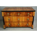 An early 19th century walnut Biedermeier chest of three long drawers flanked by ebonised pilasters