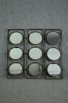 A set of three metal frames each fitted with three swing mirrors. H.90 W.31cm. (each)