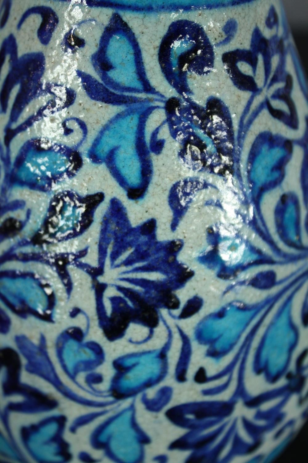 An early 20th century Multani blue and white floral hand painted vase. A little chipped with signs - Image 4 of 5