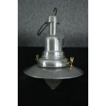 An industrial style chrome ceiling pendant light. Modern but with what looks like an older glass