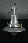 An industrial style chrome ceiling pendant light. Modern but with what looks like an older glass