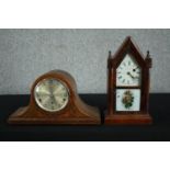 An 1870s American Gothic style clock in a steeple case with lower glass tablet decorated with roses.