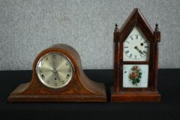 An 1870s American Gothic style clock in a steeple case with lower glass tablet decorated with roses.