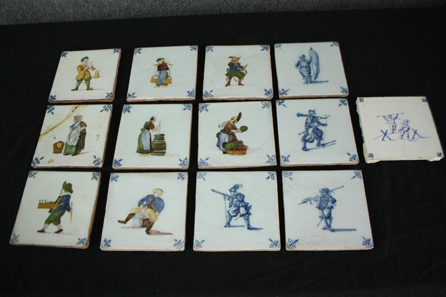 A set of thirteen early nineteenth century Dutch Makkum tiles. Eight hand painted and brightly