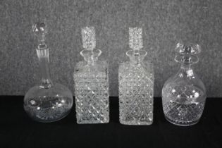 Four decanters with their stoppers. Cut glass with etched decoration. H.33cm. (largest)