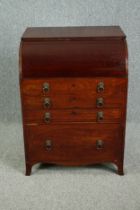 A Georgian mahogany roll top dressing table with rising lid fitted with vanity mirror. (The curved