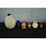 A mixed collection of glazed ceramic pots, vases and a small terracotta urn. Studio pottery. Without